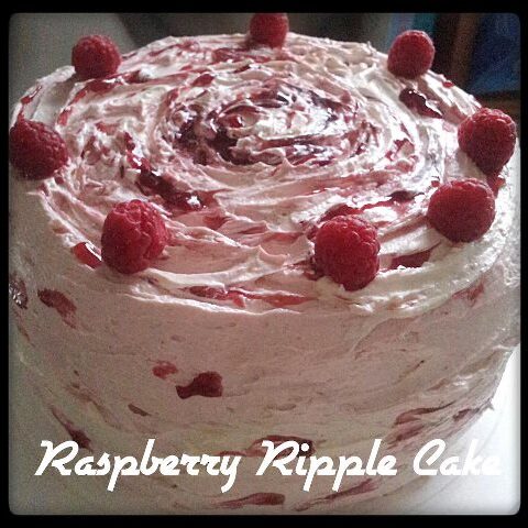 A raspberry layer Cake decorated with fresh raspberries