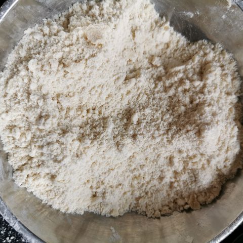 A mixture of flour and butter in a sliver bowl 