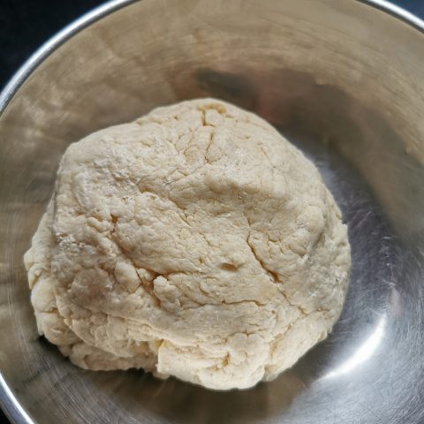 A ball of scone dough In a silver bowl