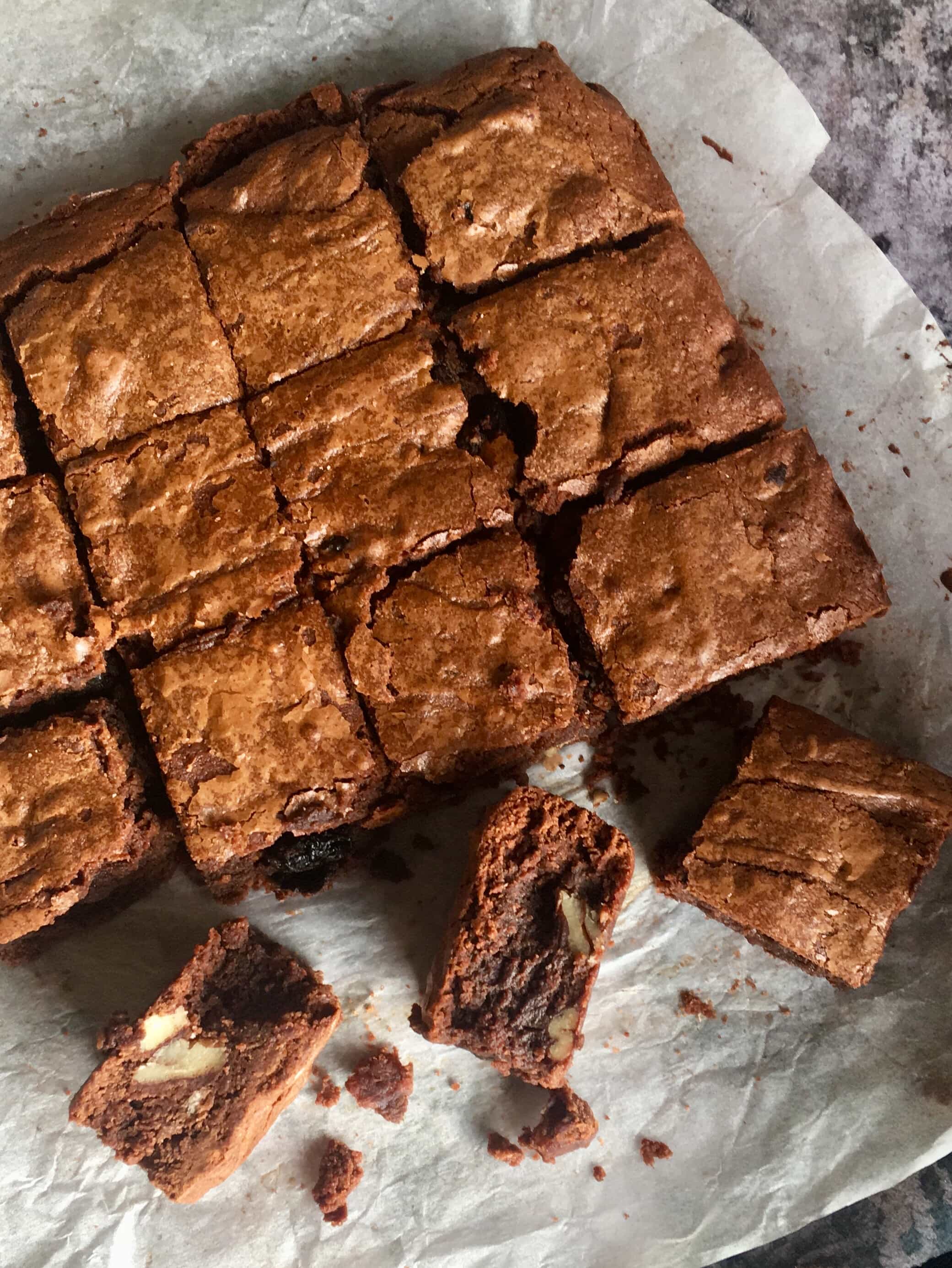 Cherry Brandy and Pecan Brownies on a crumpled piece of baking parchment 