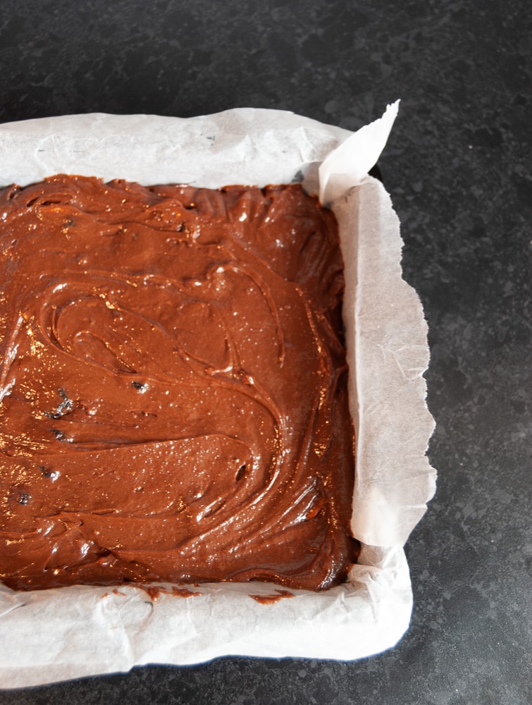 A tray of unbaked cherry and pecan brownies ready for the oven