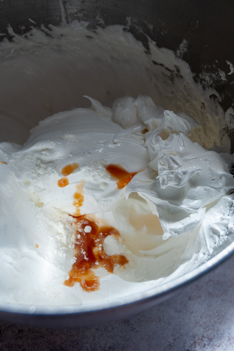 a bowl of whipped egg whites, sugar, vanilla extract and cornflour for making pavlova