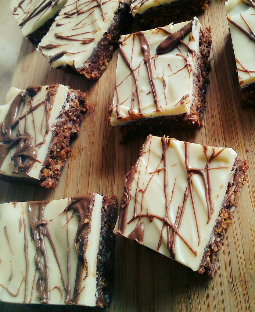 Honey and milk chocolate bars on a wooden board 