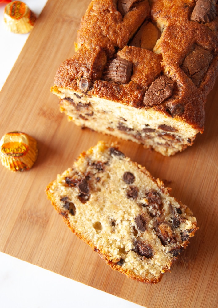 A peanut butter cup banana bread on a wooden board