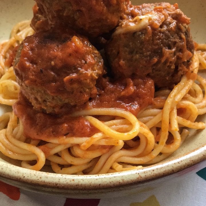 A bowl of beef Meatballs with tomato sauce and spaghetti