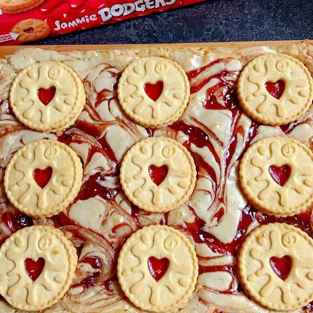 A uncut tray of Blondies with jam swirls and jammie dodger biscuits.