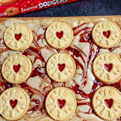 a blondie traybake with strawberry jam swirls and heart shaped cookies