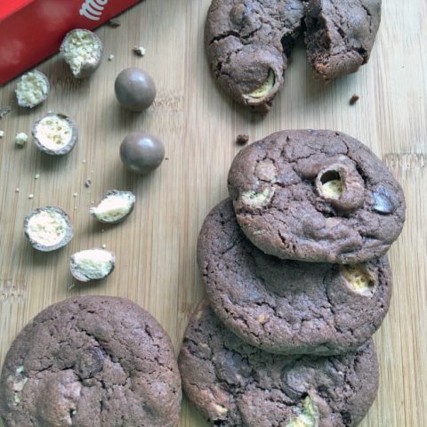 Double chocolate malteser cookies on a wooden background