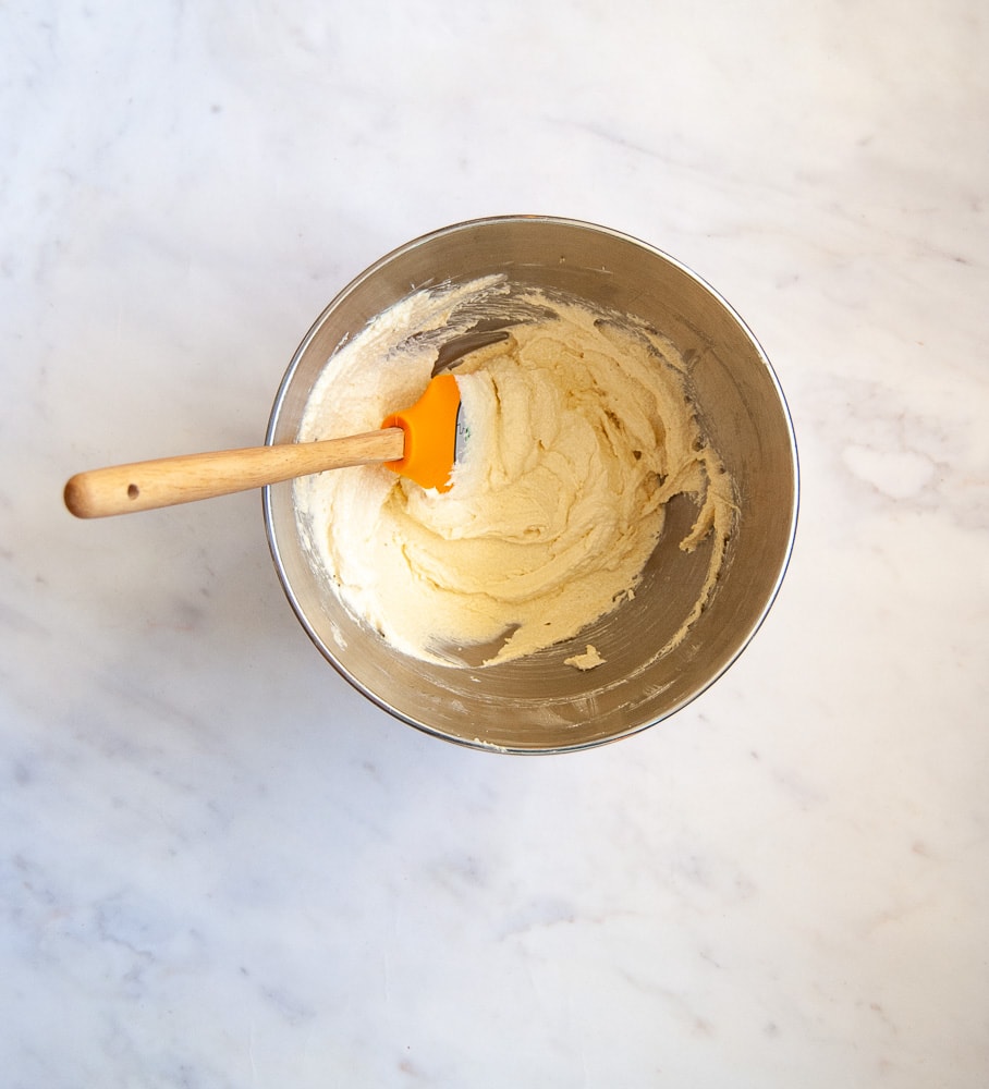 a silver bowl of butter and brown sugar for making chocolate pretzel cookies