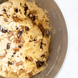 A silver bowl of chocolate pretzel cookie dough