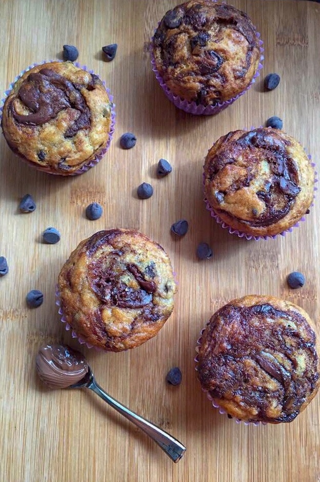 Five Chocolate Chip Banana Nutella Muffins on a wooden board