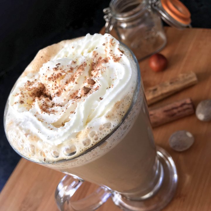 Pumpkin spice latte in a tall latte glass