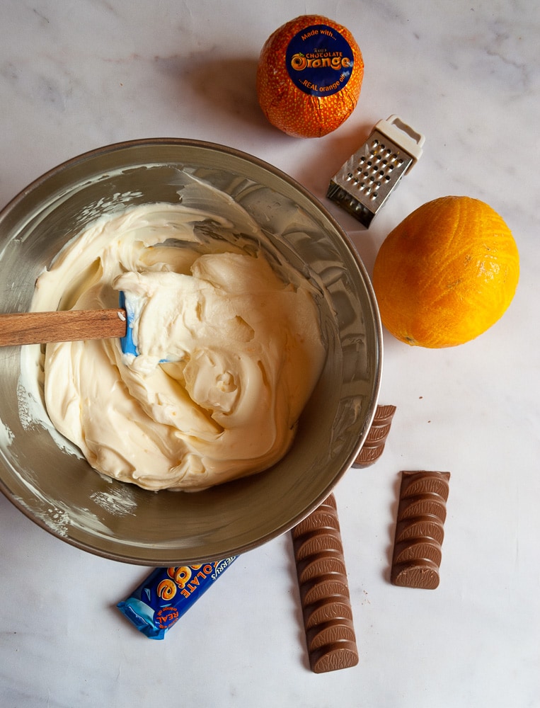 A bowl of cream cheese, icing sugar and double cream to make a no bake cheesecake