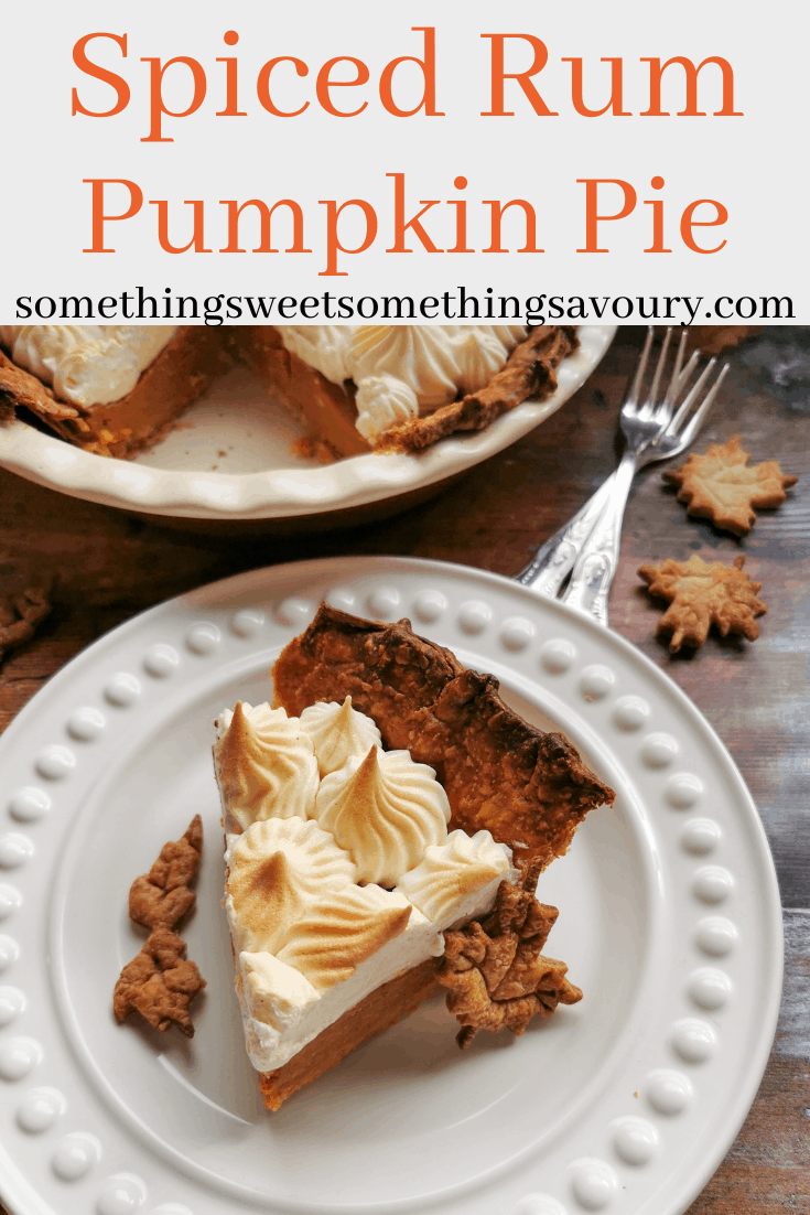 A Pinterest pin with the words "spiced rum pumpkin pie" with a picture of a slice of pumpkin pie on a white plate decorated with pastry leaves