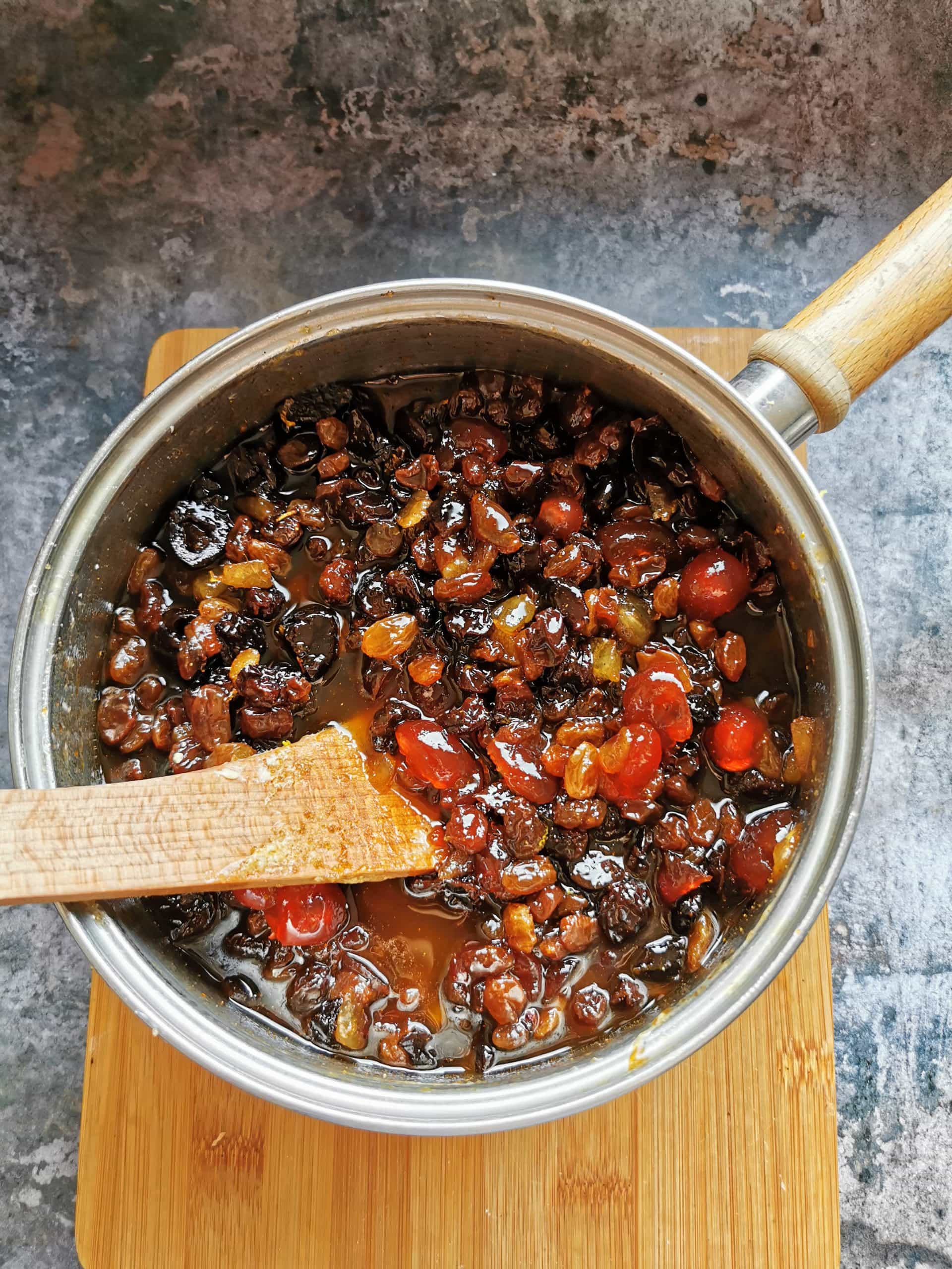 A saucepan of mixed dried fruit soaking in Amaretto for making fruit cake