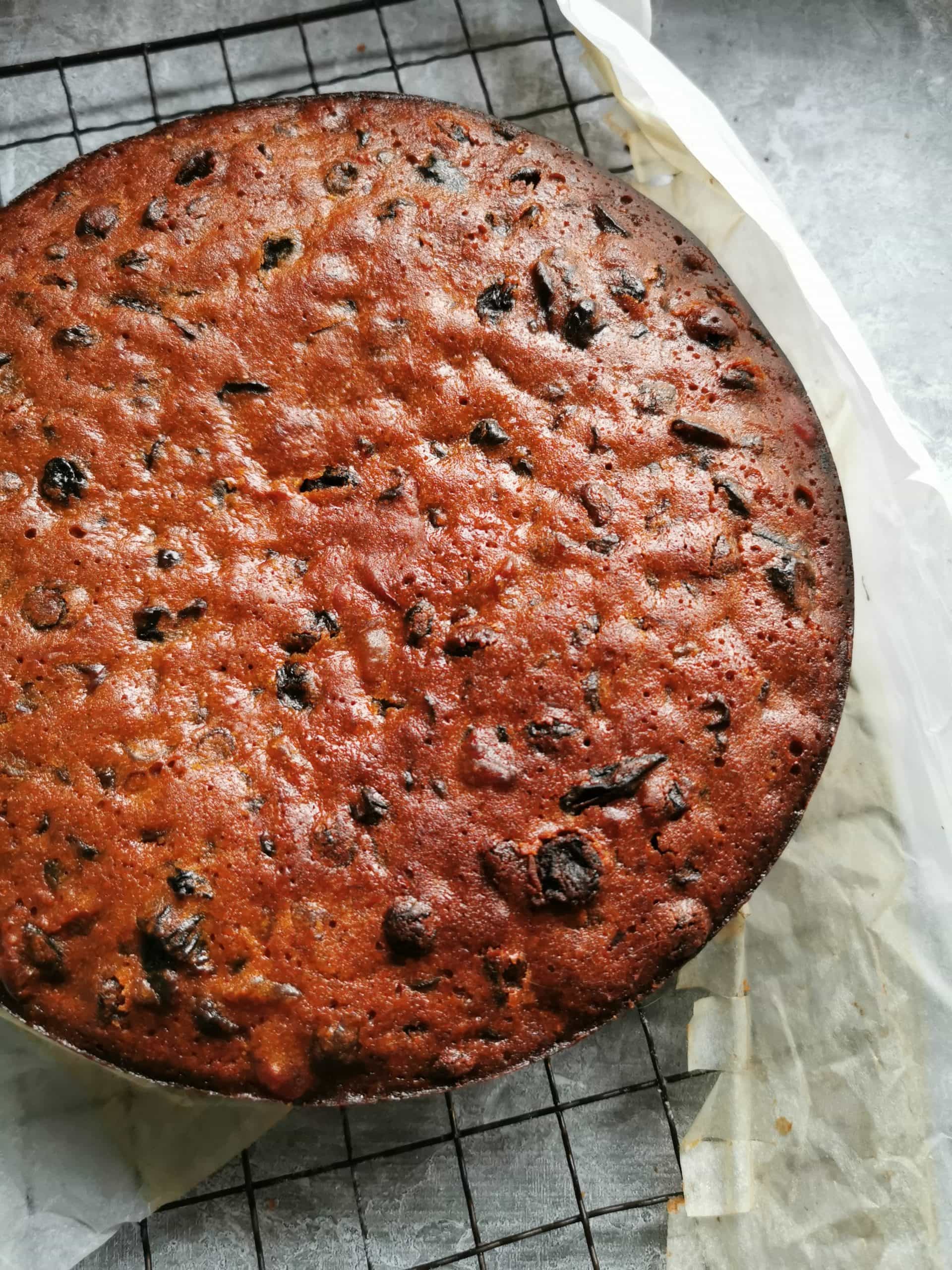 A fruit cake on a wire rack 