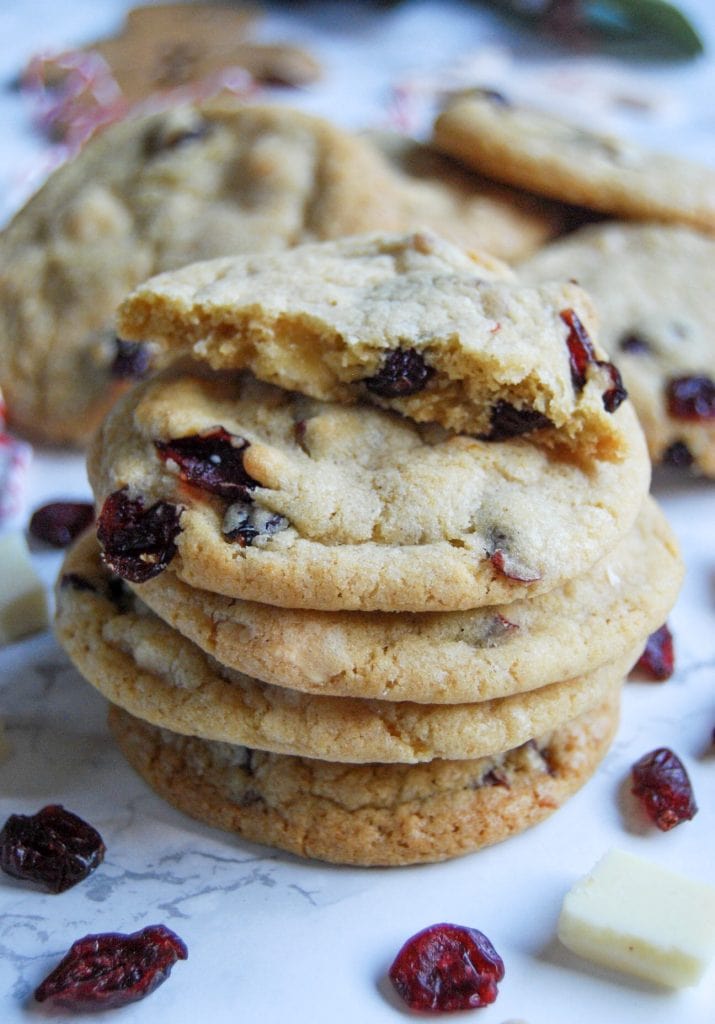 A stack of white chocolate cranbery cookies on a white marbled background.