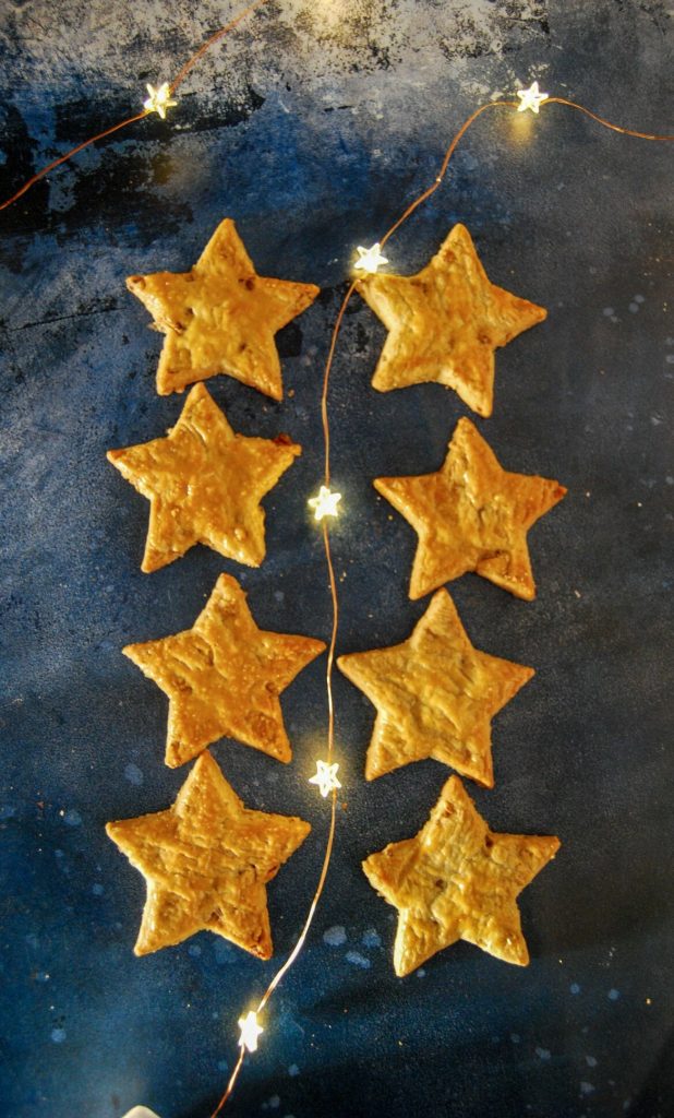 eight cheese star biscuits on a dark blue background with fairy lights