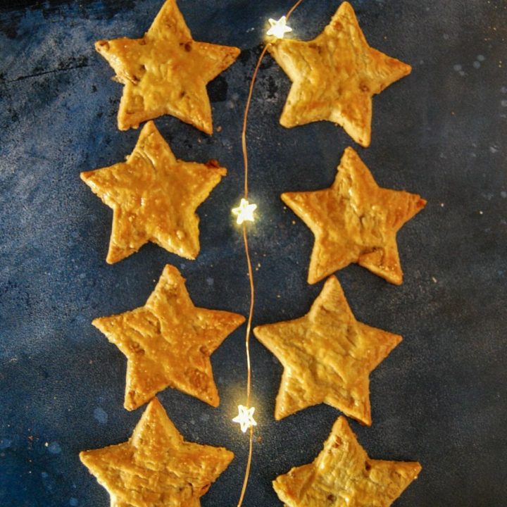 eight cheese star biscuits on a dark blue background with fairy lights