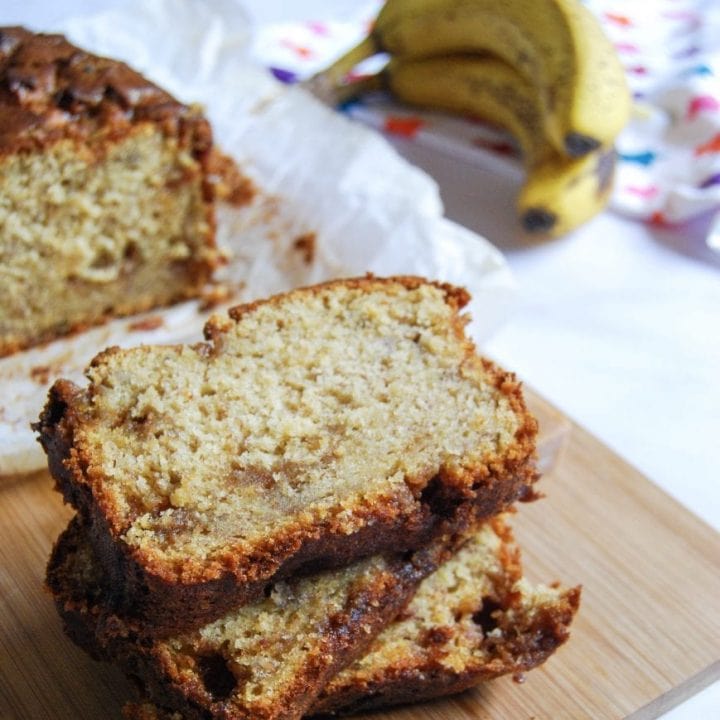 Slices of banana fudge loaf on a wooden board.