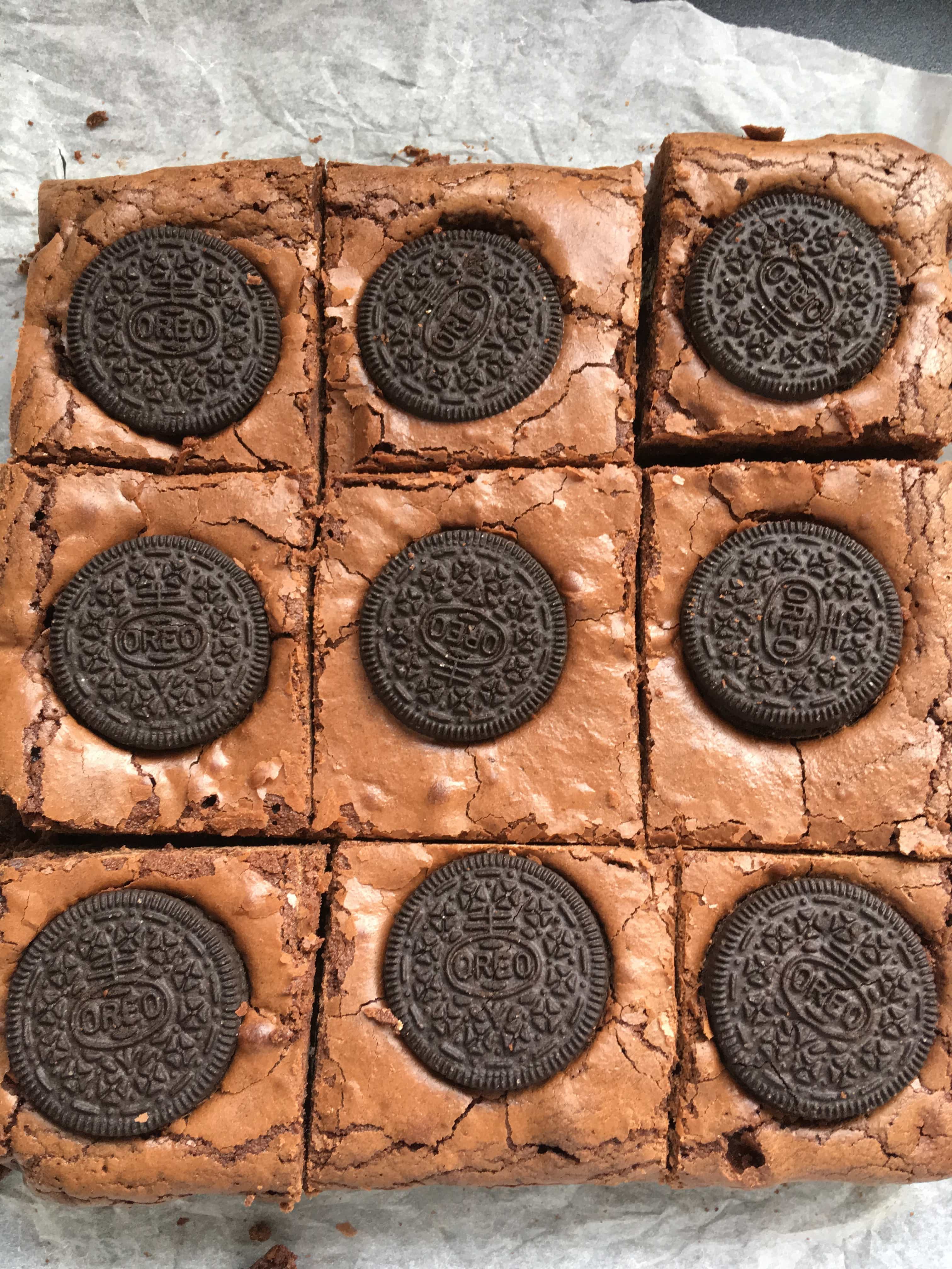 9 Mint Oreo Brownies on a sheet of crumpled baking parchment. 