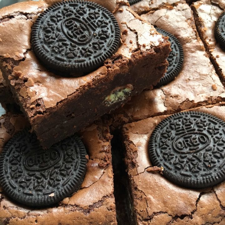 A stack of Mint Oreo Brownies with a mint chocolate oreo filling.