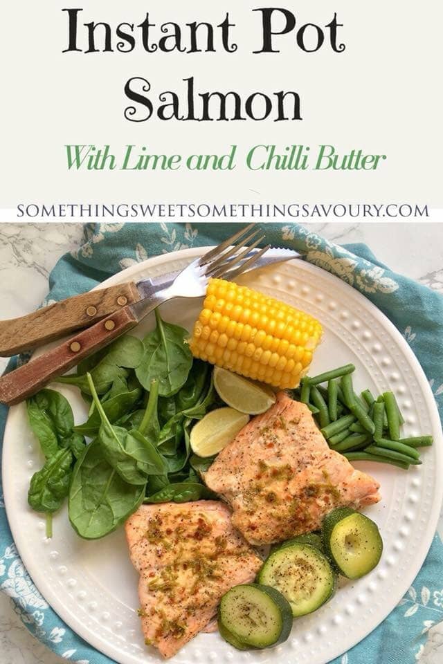 a pinterest pin with the words "instant pot salmon with lime and chilli butter" and a picture of salmon fillets on a white plate with corn on the cob, spinach, green beans and courgettes.