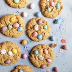 Mini Egg Cookies on a light pastel blue background with mini pastel chocolate eggs.