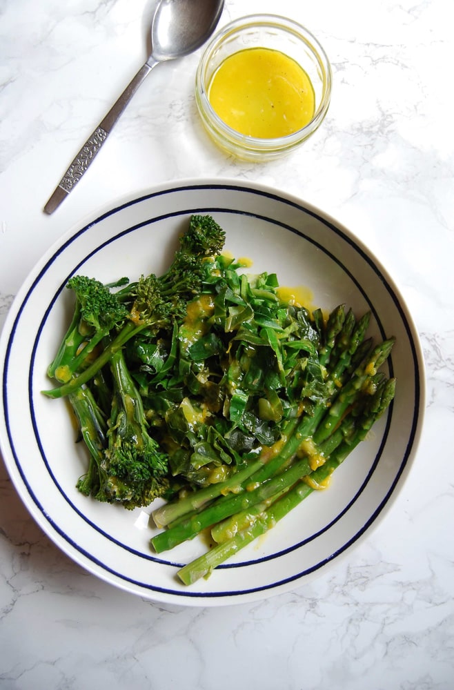 A bowl of Spring greens with a lemon mustard dressing 
