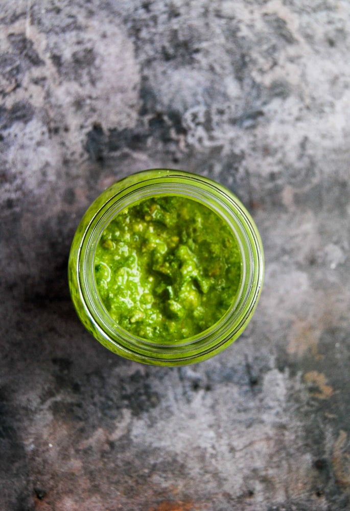 A flatlay photo of a jar of wild garlic pesto 