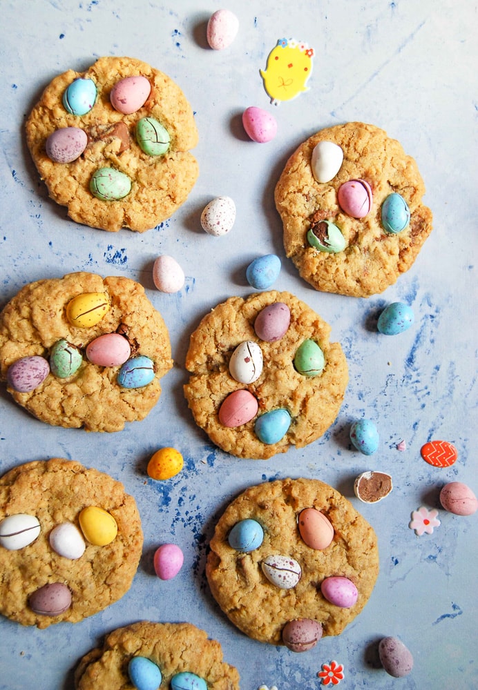 Mini Egg Cookies on a light pastel blue background with mini pastel chocolate eggs.