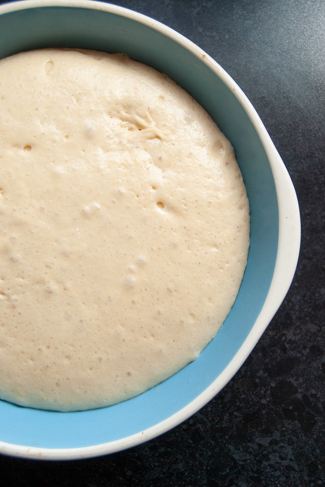 a bowl of risen brioche dough.