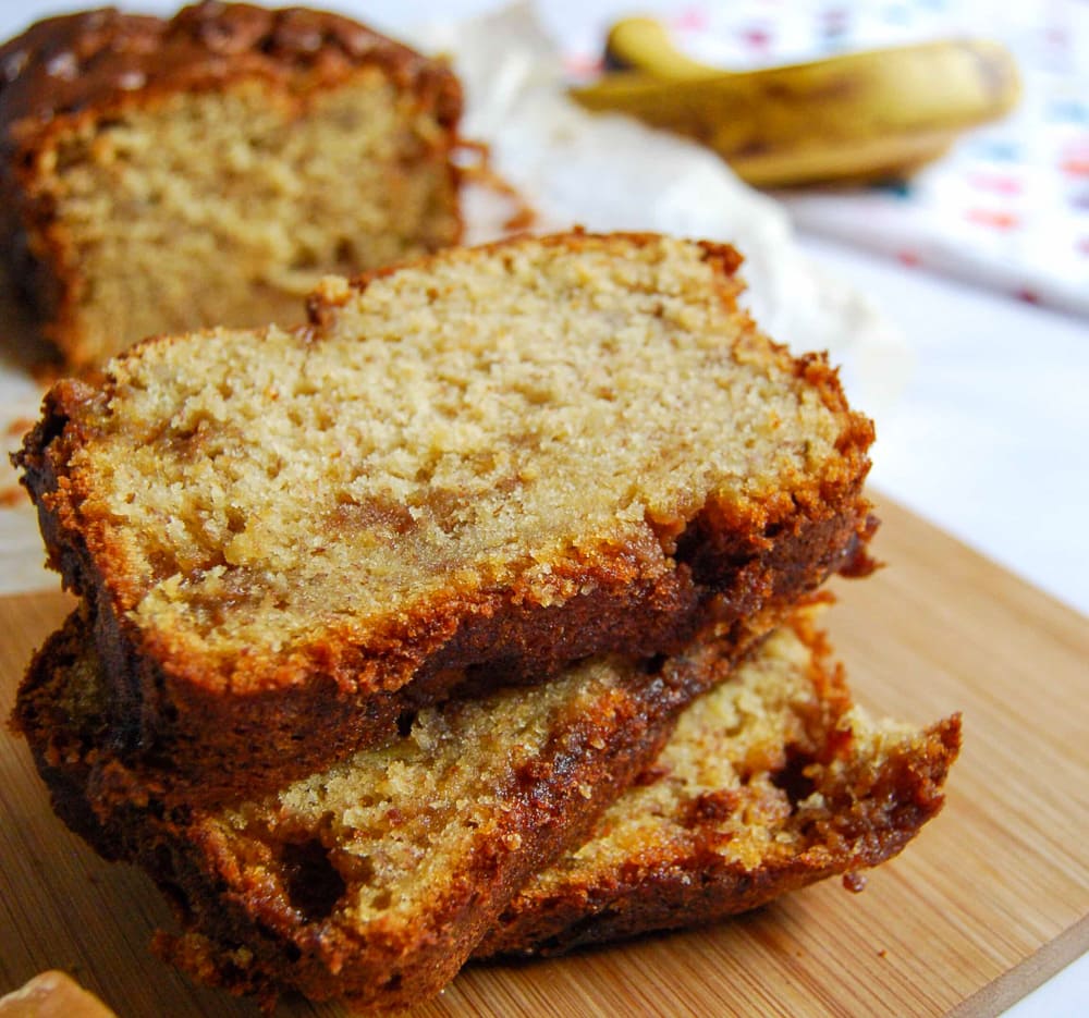 A close up picture of slices of banana fudge loaf on a wooden board.