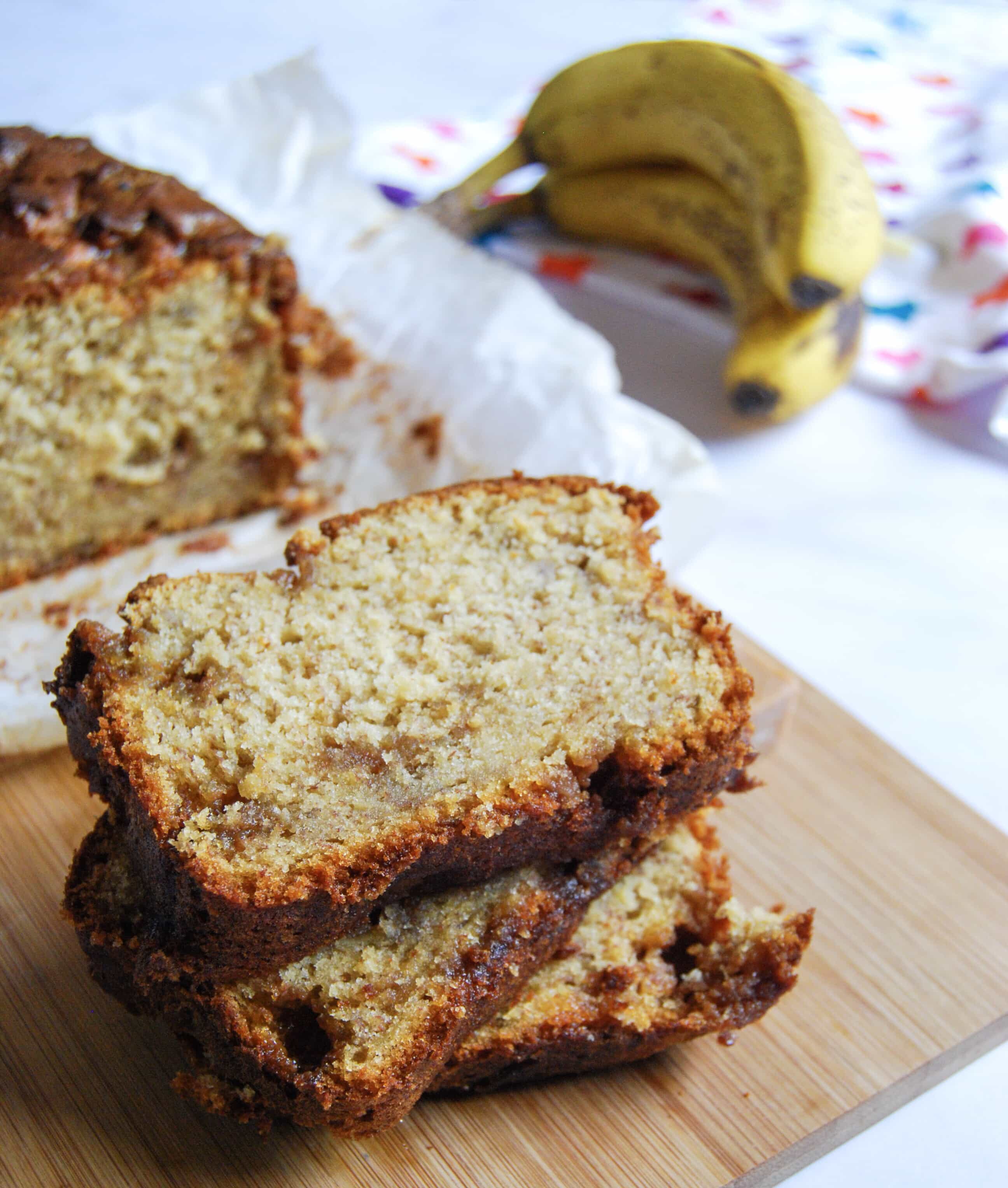 A photo of slices of banana fudge loaf on a wooden board.