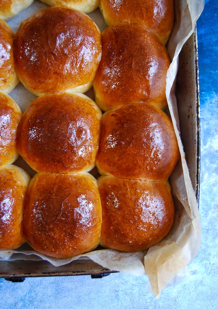 A tray of homemade brioche burger buns.