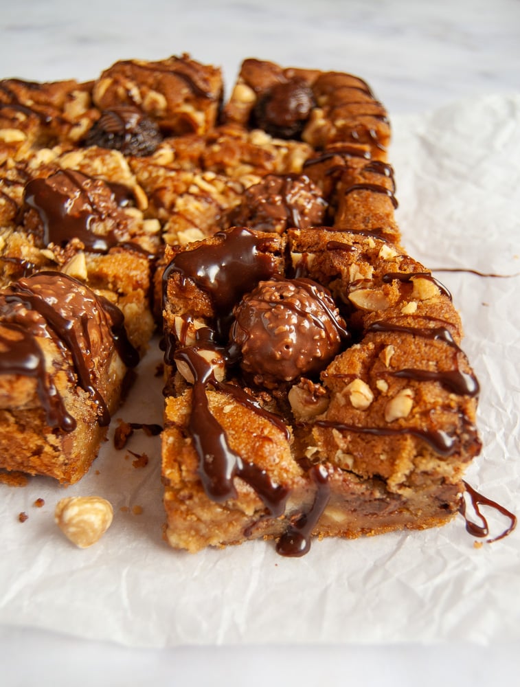 A close up photo of a Ferrero Rocher Blondie drizzled with a Nutella glaze