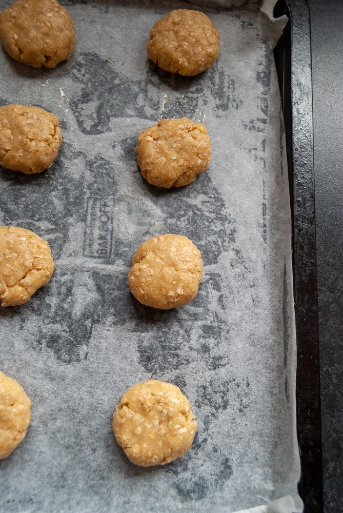 a tray of unbaked raw oat biscuits