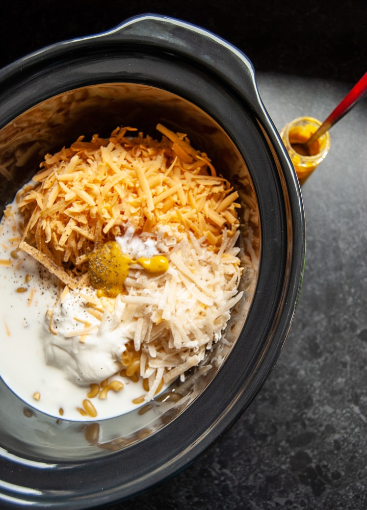 dried Macaroni, milk, grated cheese, mustard and salt and pepper in a slow cooker. 