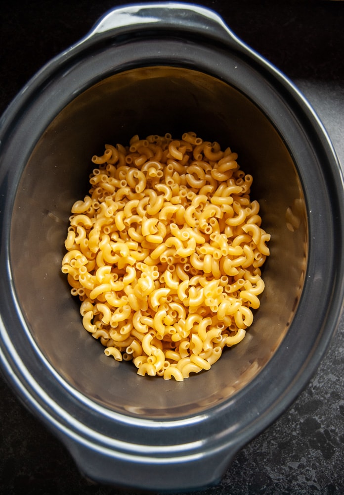 dried elbow macaroni pasta shapes in a slow cooker