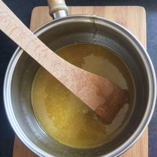 A pan of melted butter and syrup for making Fruity Flapjacks