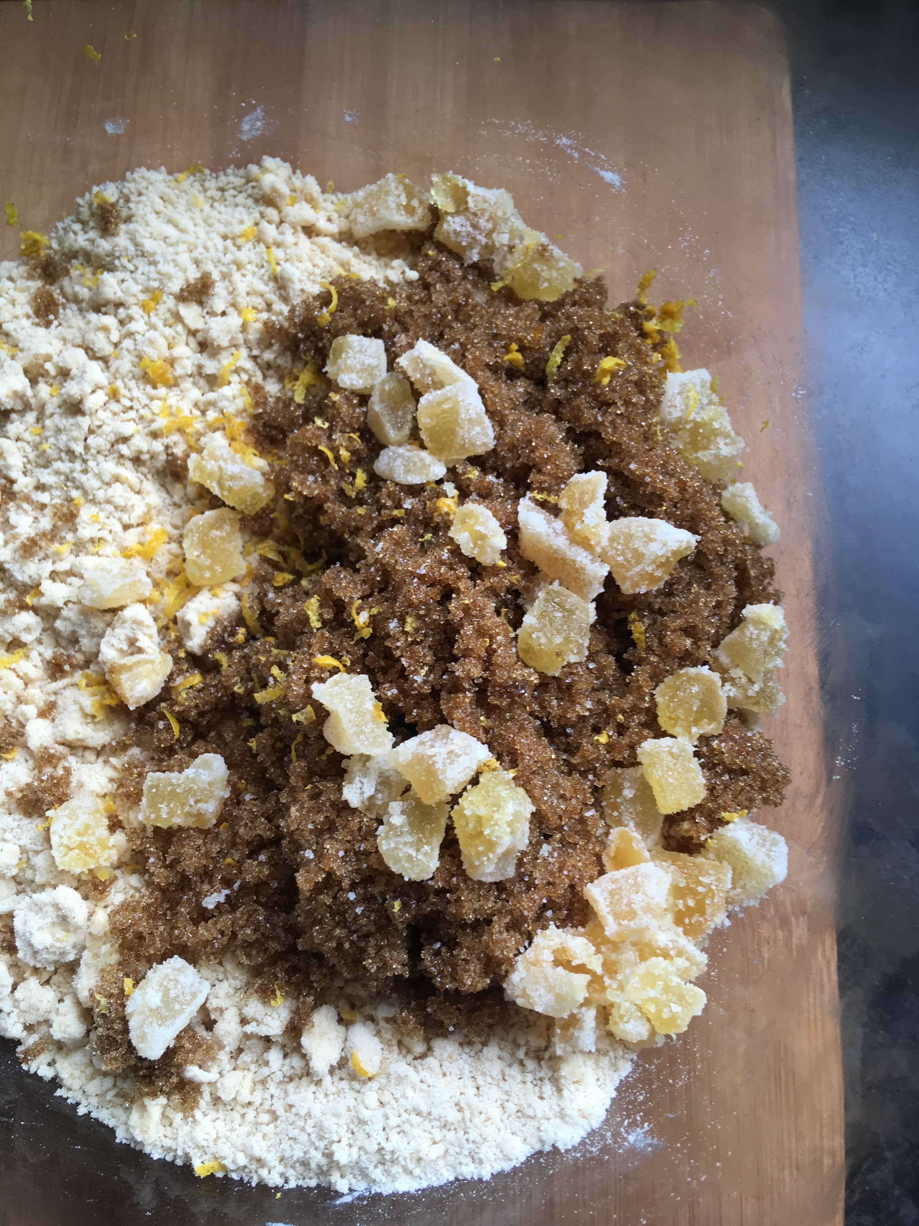 a bowl of brown sugar and crystallised ginger pieces.