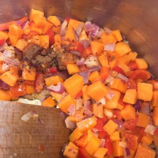 A pan of vegetables for making sweet potato and lentil soup
