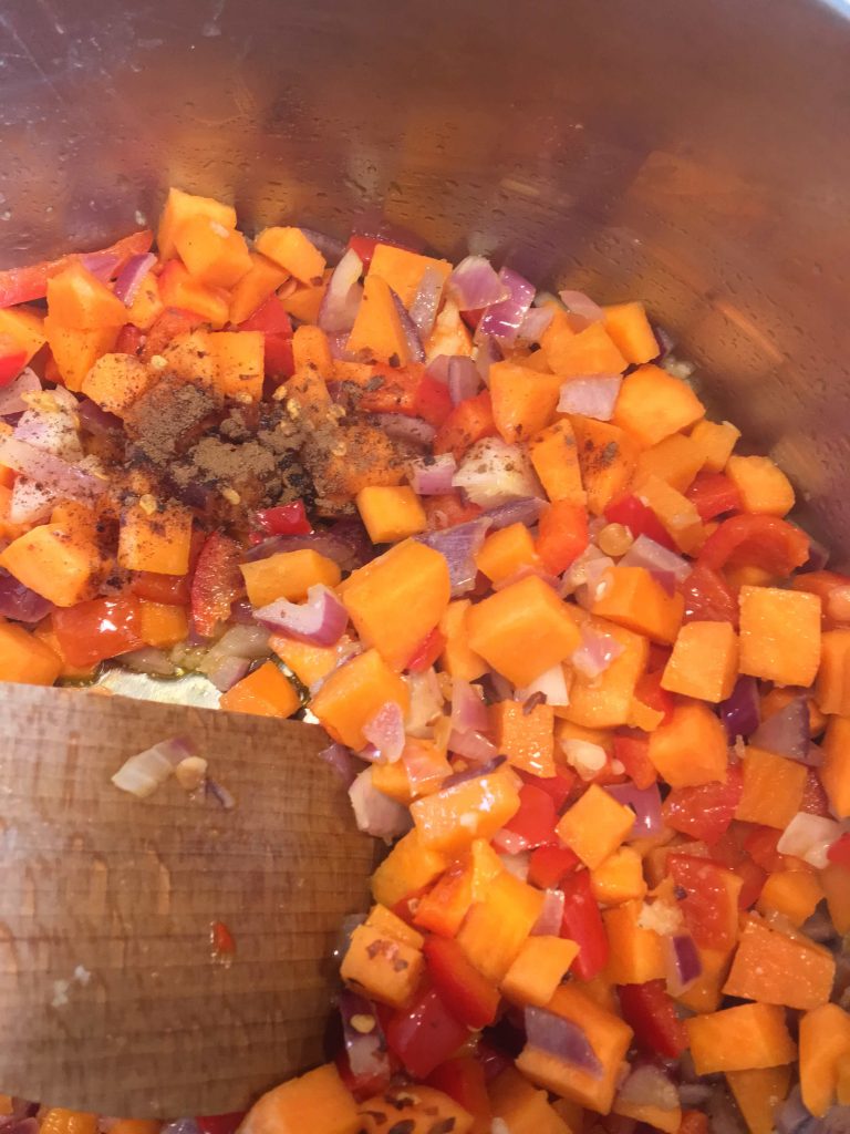 A pan of vegetables for making sweet potato and lentil soup