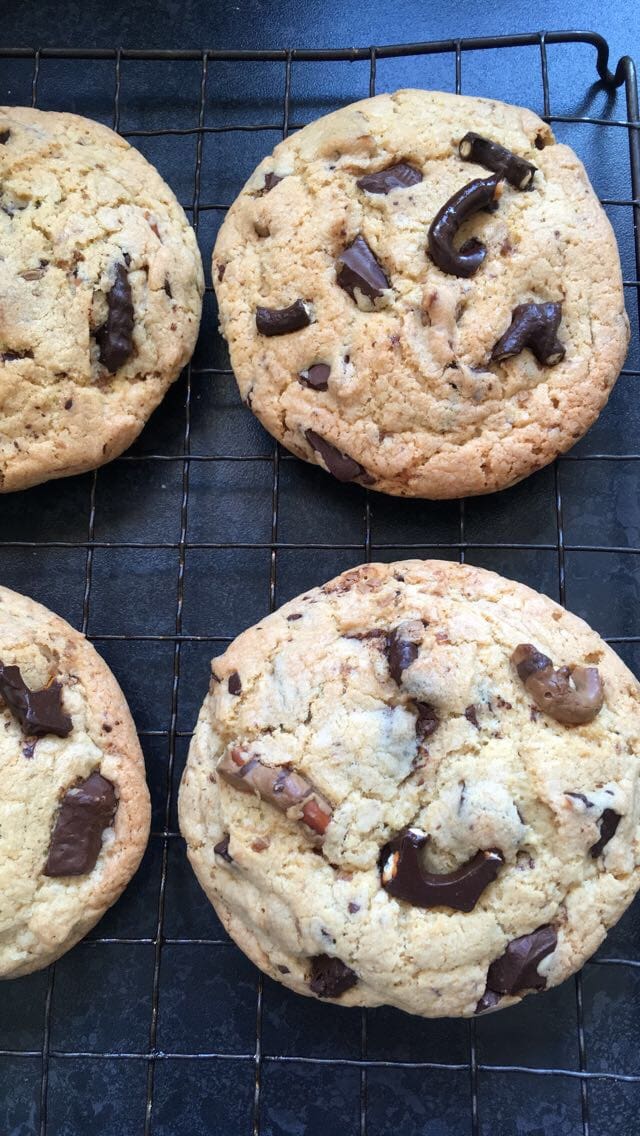 Freshly baked chocolate pretzel cookies on a wire rack