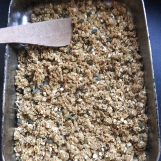 A tray of unbaked pumpkin spice granola