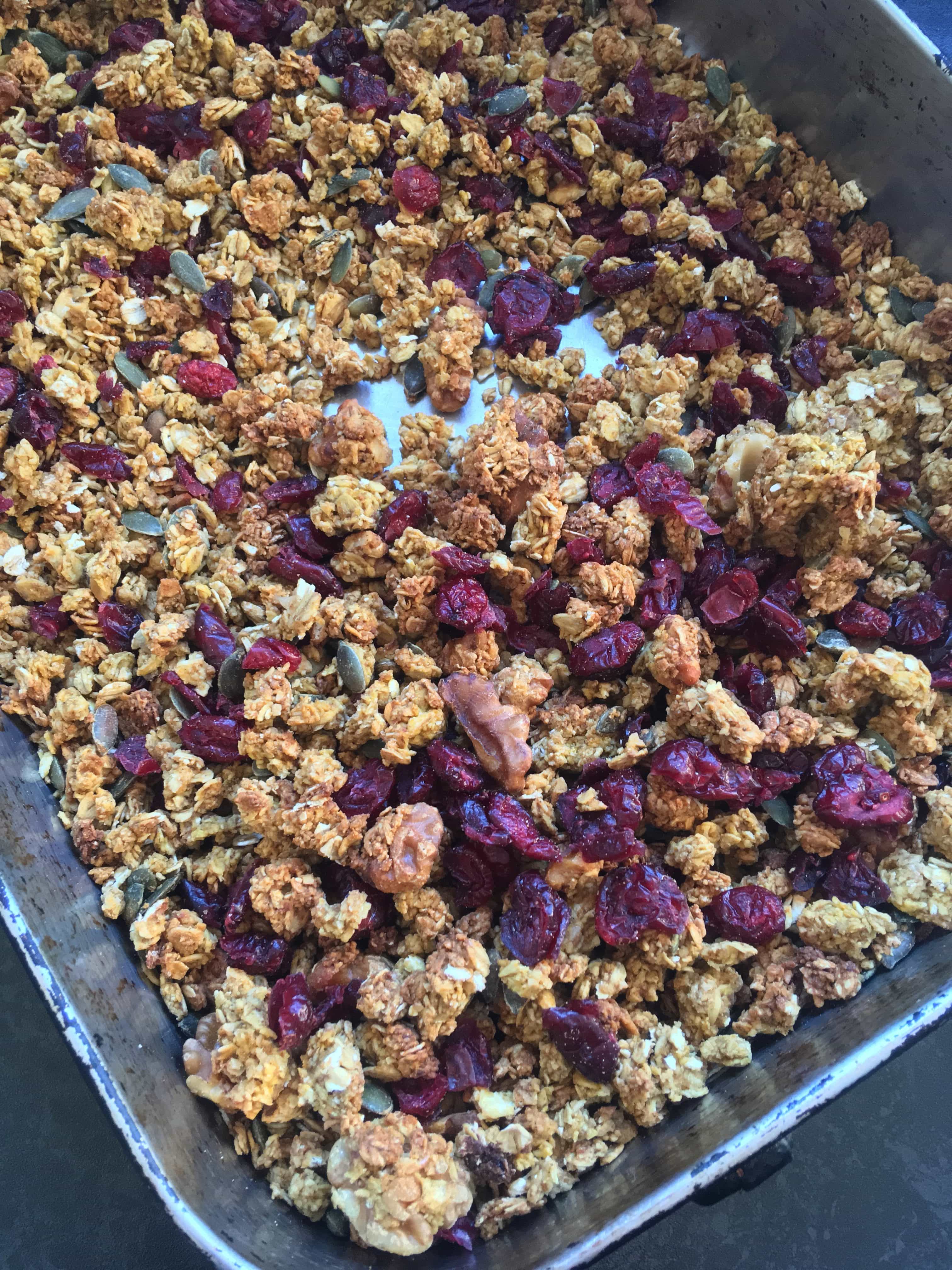 A tray of pumpkin granola with walnuts and dried cranberries