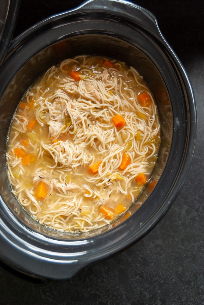 A crock pot of homemade chicken noodle soup