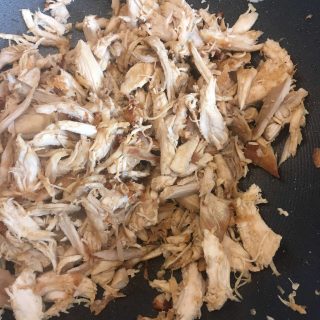 Cooked chicken in a large wok