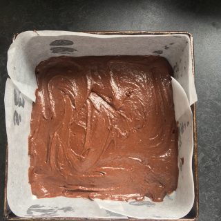 A tin of unbaked brownie batter