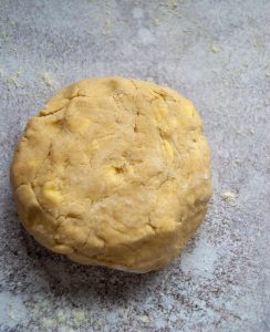 Pie dough on a grey background.